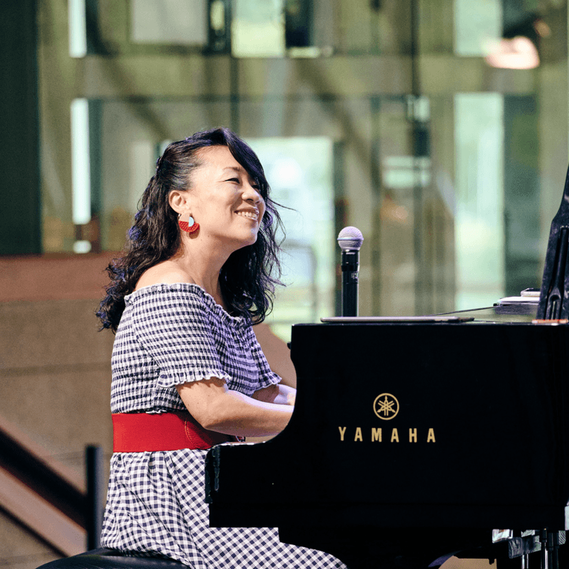 a Woman Playing Piano Smiling